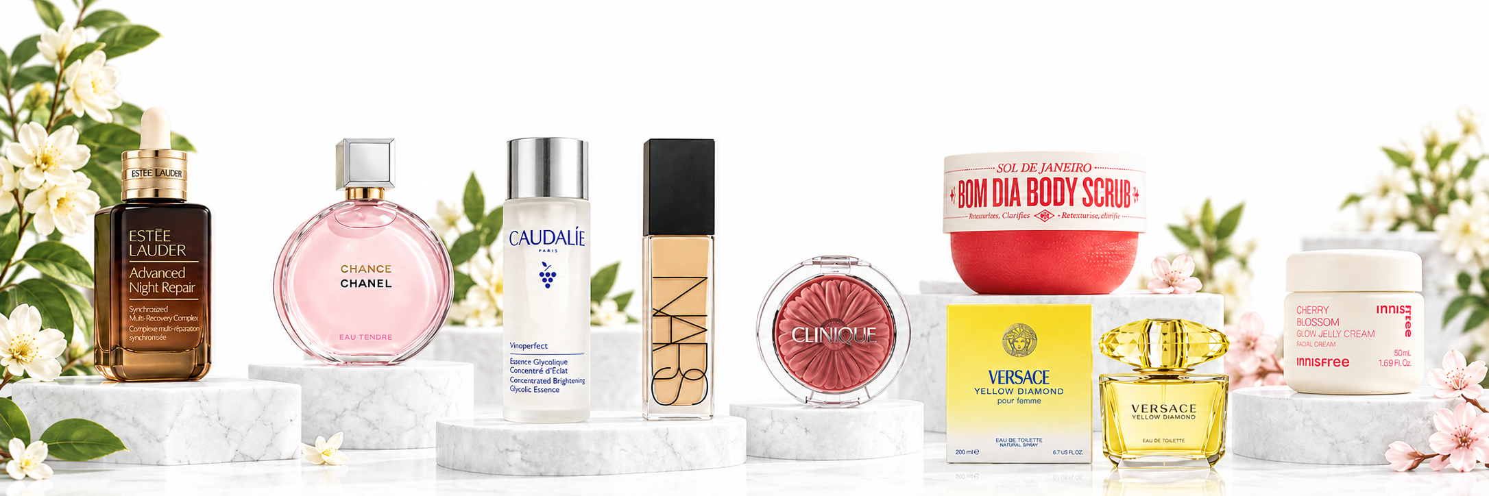 Beauty products arranged together on white display platforms